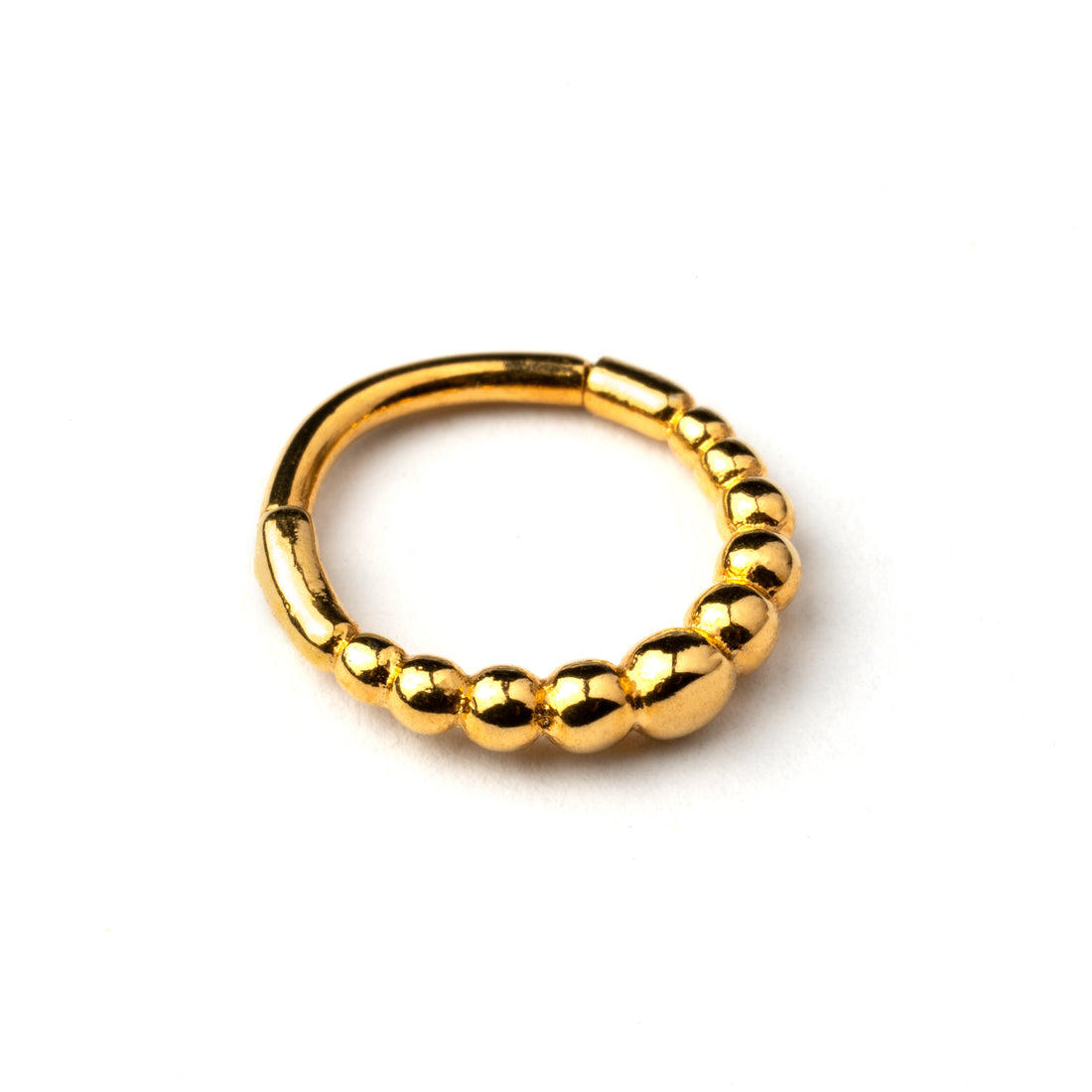 Golden surgical steel clicker piercing ring formed by tiny spheres