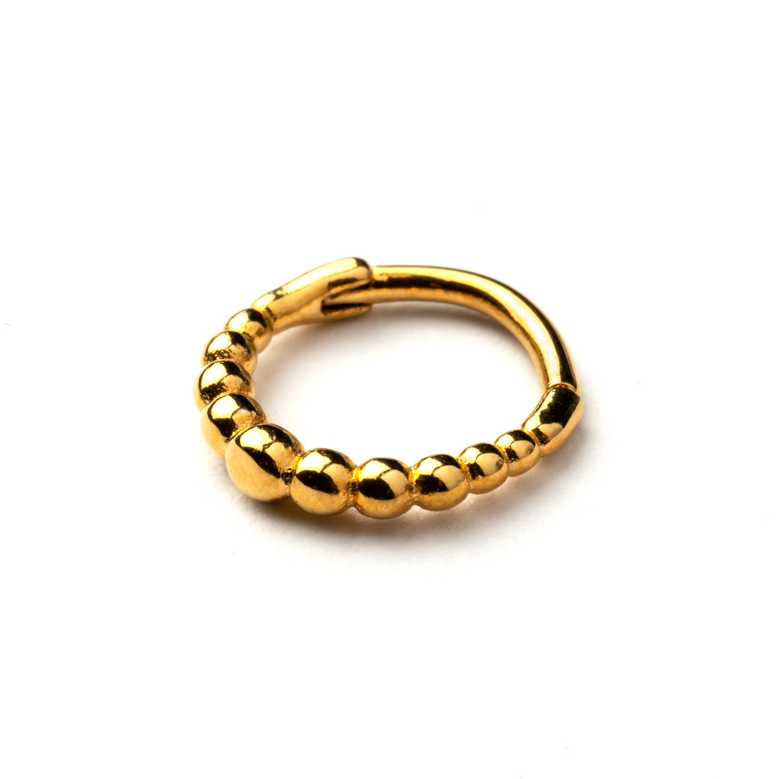 Golden surgical steel clicker piercing ring formed by tiny spheres down view
