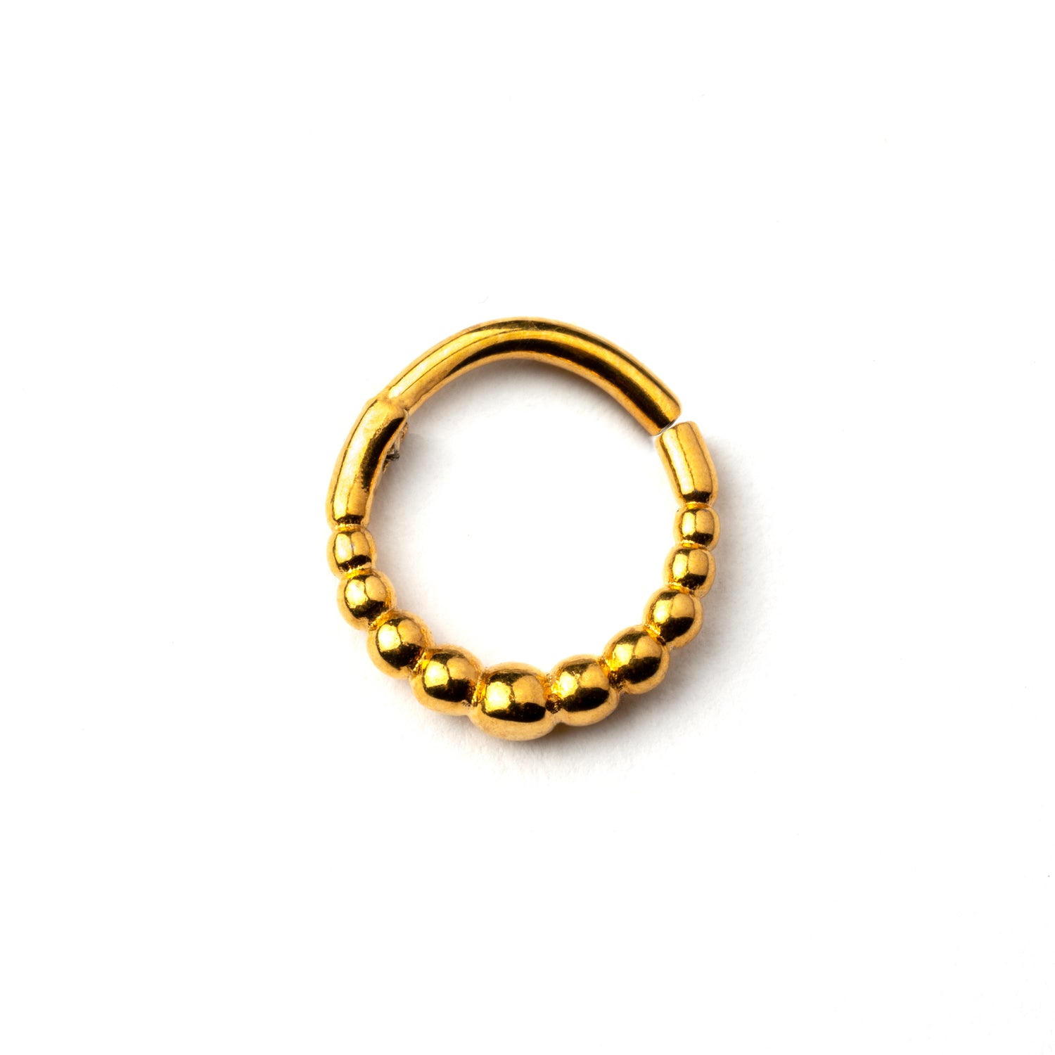 Golden surgical steel clicker piercing ring formed by tiny spheres frontal