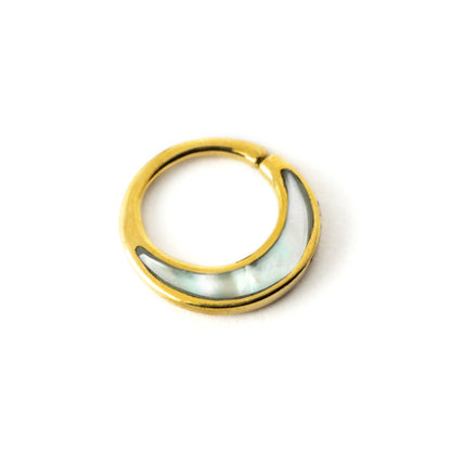 Golden brass septum piercing ring with mother of pearl inlay left side view
