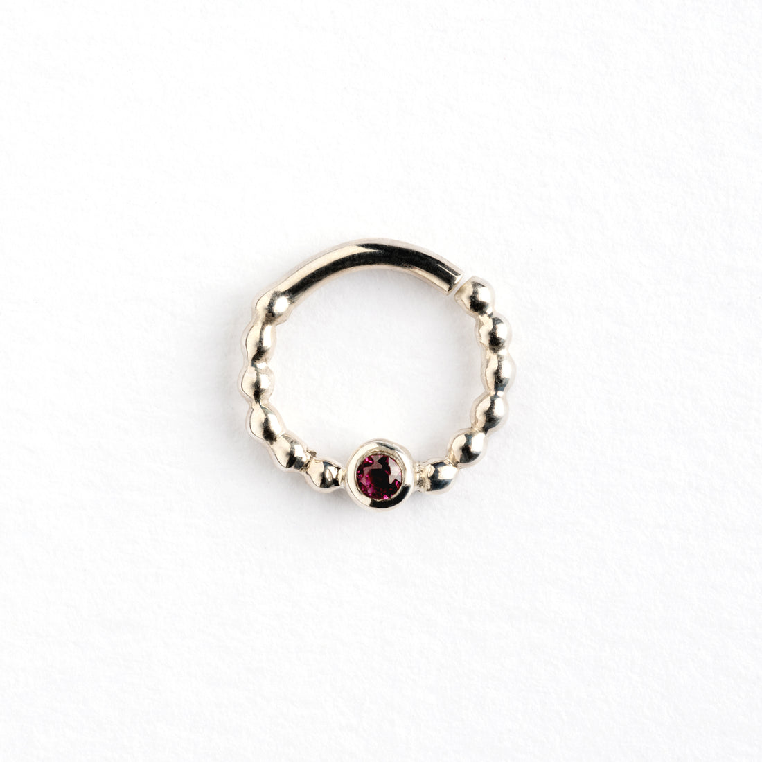 sterling silver dotted septum ring with Garnet gemstone frontal view