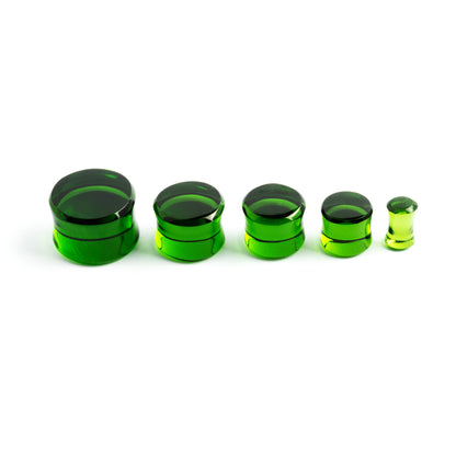 several sizes of Green Obsidian stone double flare ear plugs front view