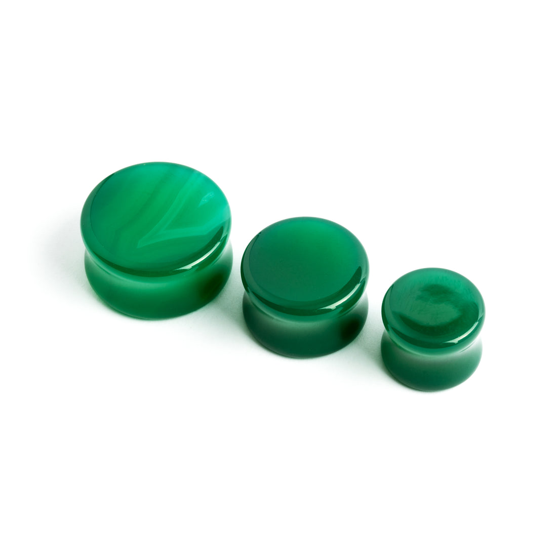 several sizes of green onyx double flare stone ear plugs front view