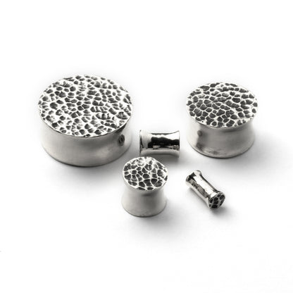 several sizes of hammered silver double flared ear plugs all view