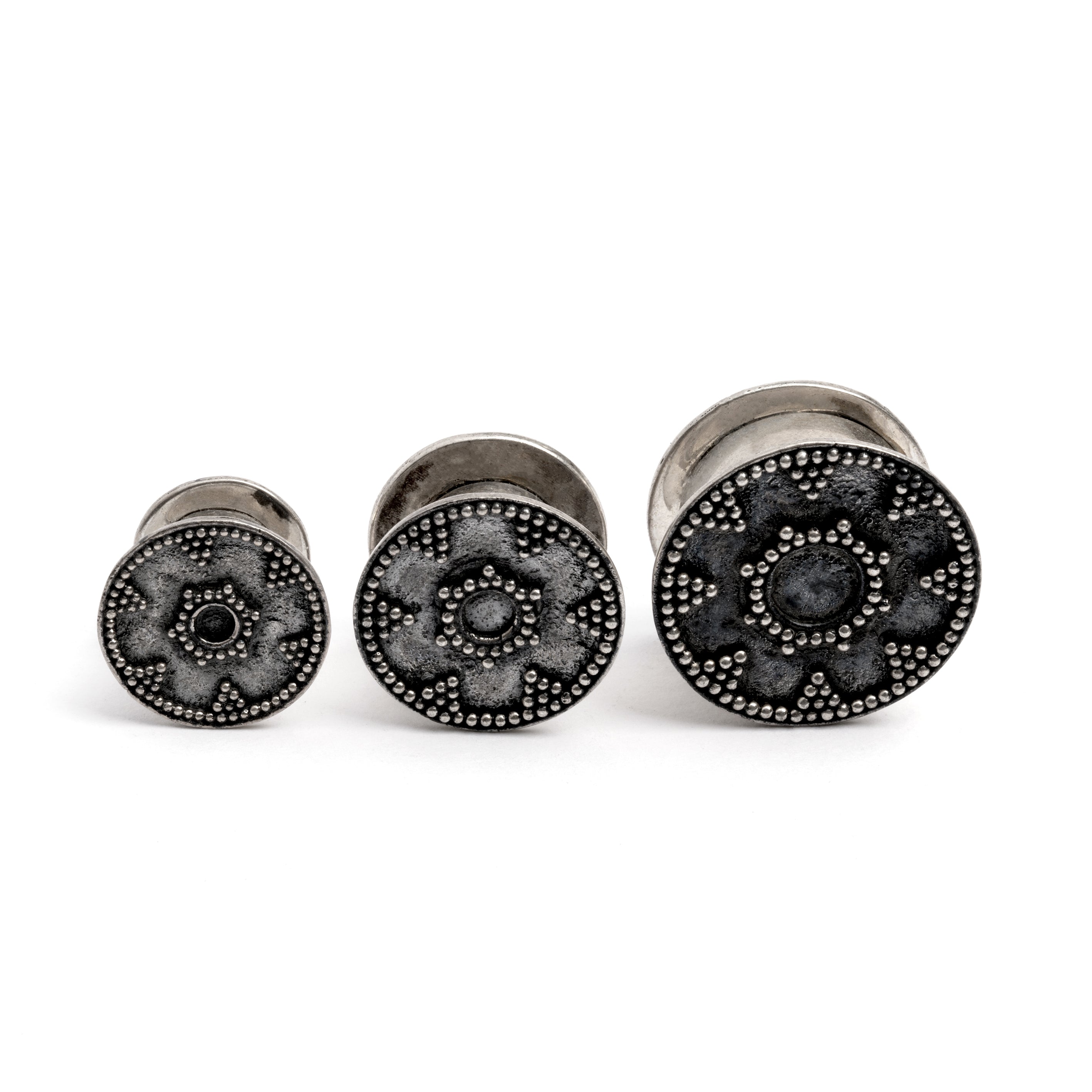 different sizes tribal screw on silver plug tunnel ornamented with spheres frontal view