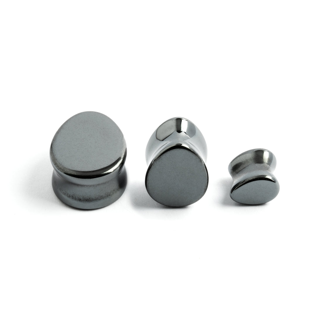 several sizes of  hematite stone teardrop shaped ear plugs front and side view