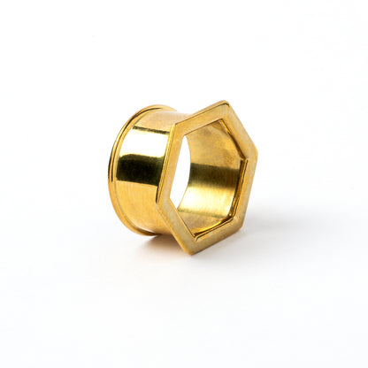 single golden brass hexagon ear tunnels right side view