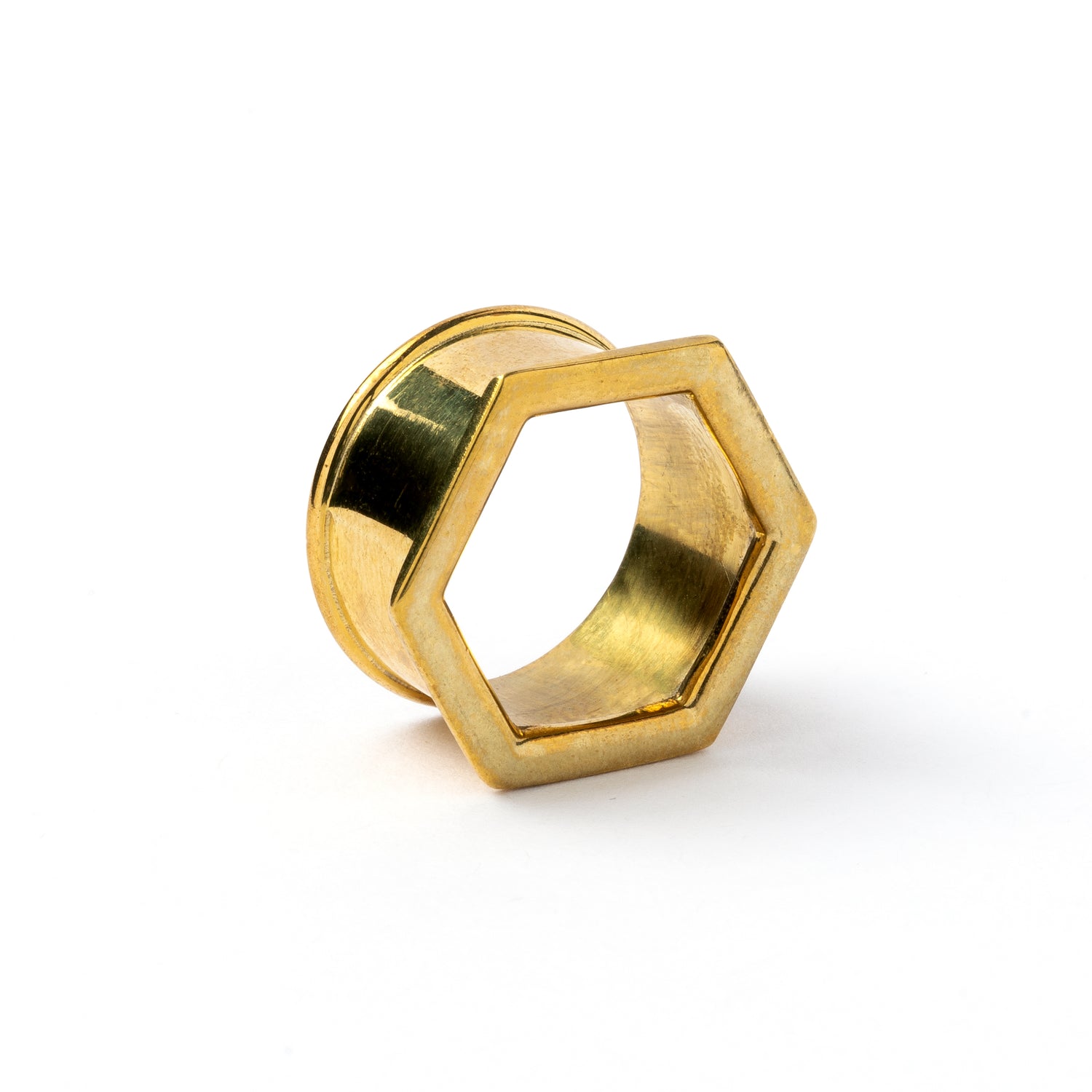 single golden brass hexagon ear tunnels front right side view