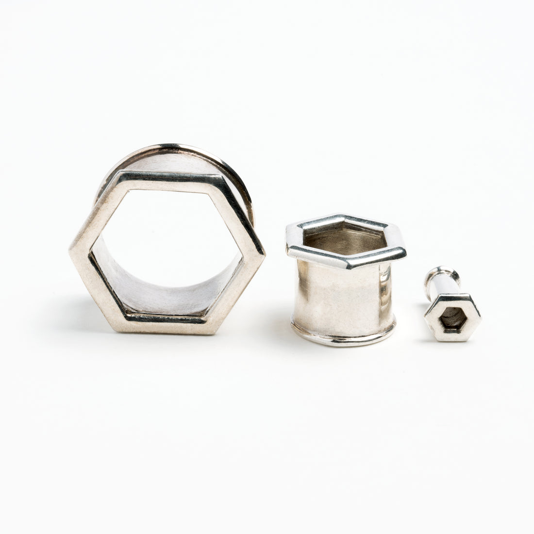 several sizes of hexagon ear tunnels front and side view