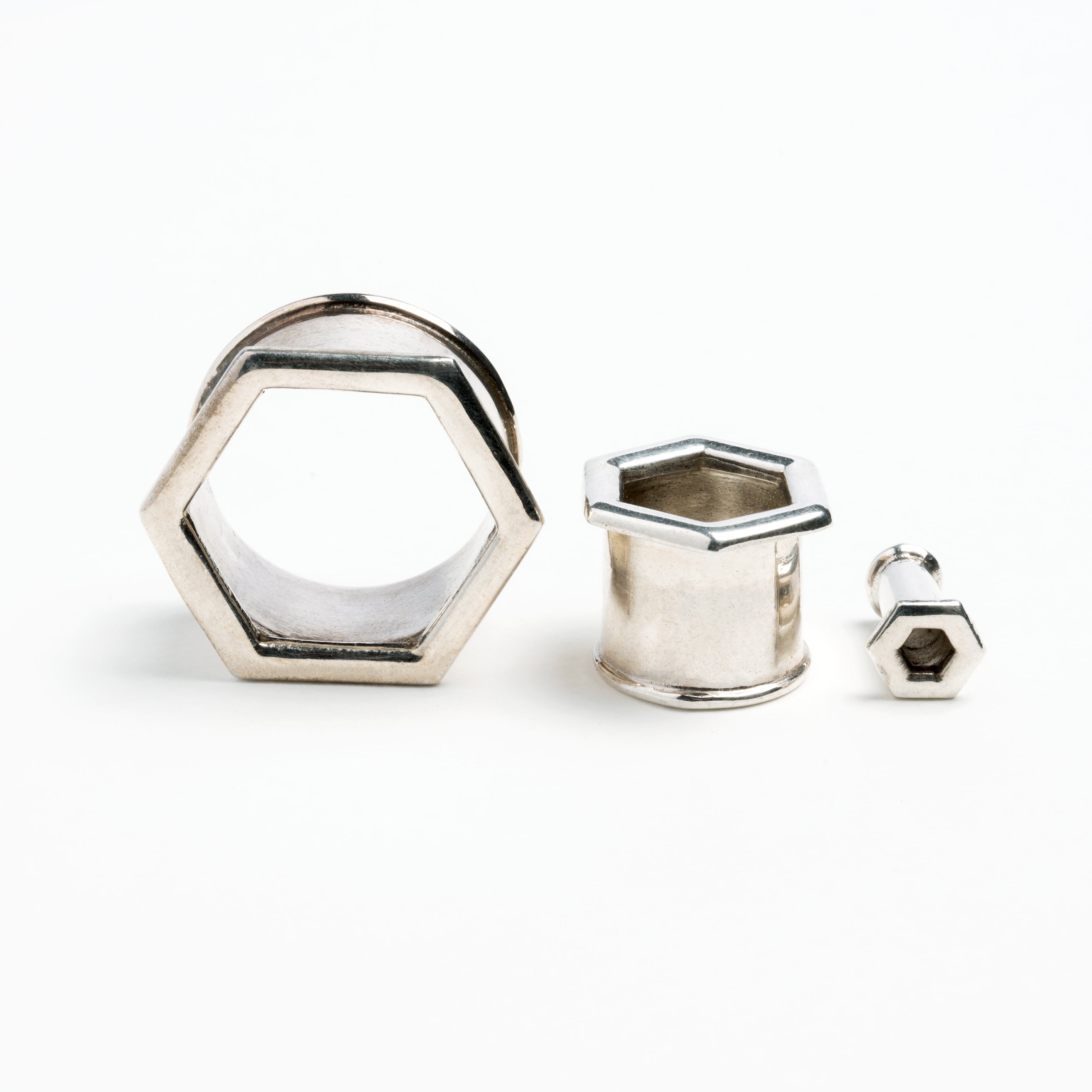 several sizes of hexagon ear tunnels front and side view 