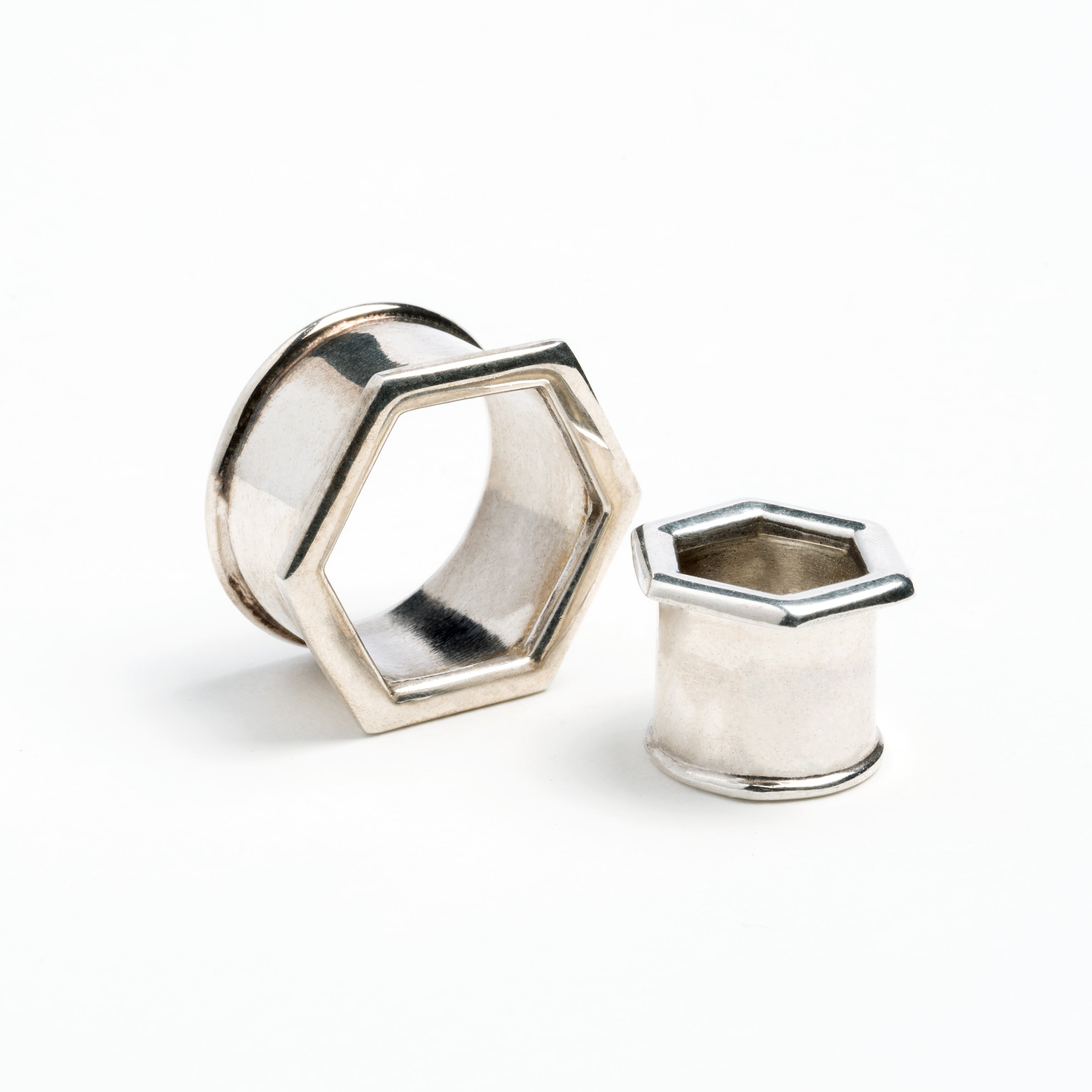 two sizes of hexagon ear tunnels front and side view 