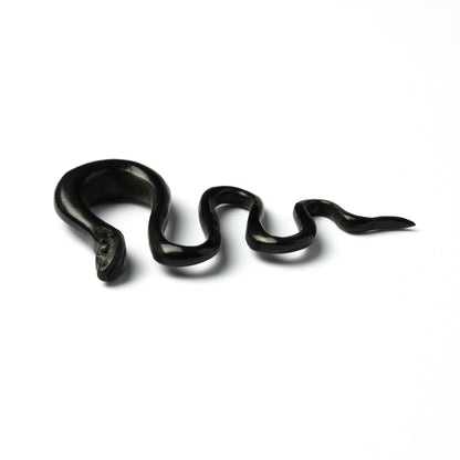 single black horn snake shaped ear stretcher side close up view