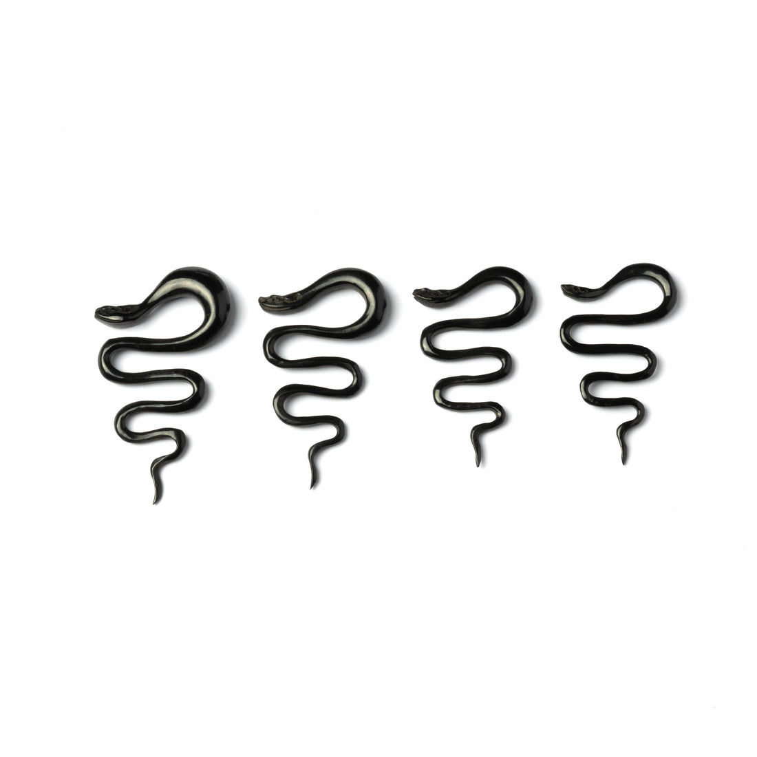 several sizes of black horn snake shaped ear stretchers side view