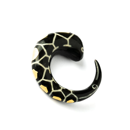 single horn ear stretcher with brass hexagons, curved hook shaped left side view