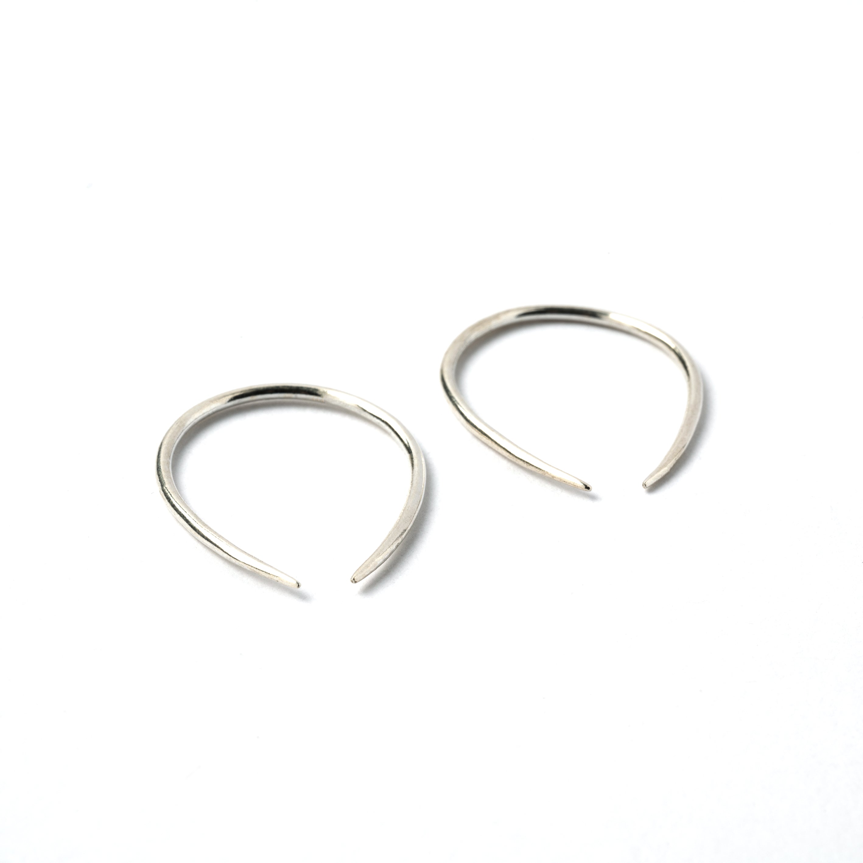 pair of 1mm silver wire horseshoe earrings down left view