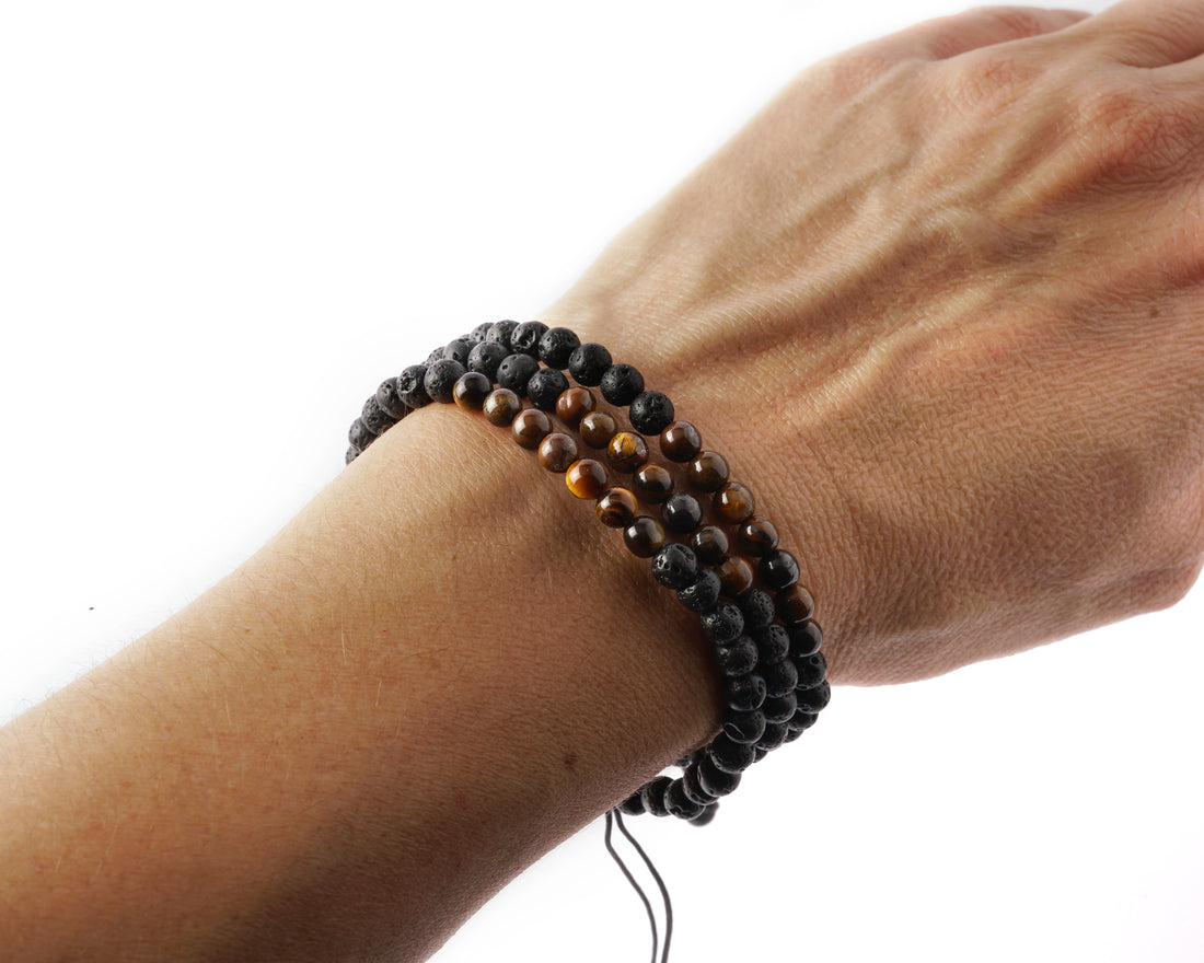 small size three Lava &amp; Tiger Eye beads bracelets on a woman wrist