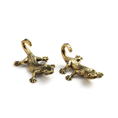 pair of gold brass lizard ear hangers close up side view