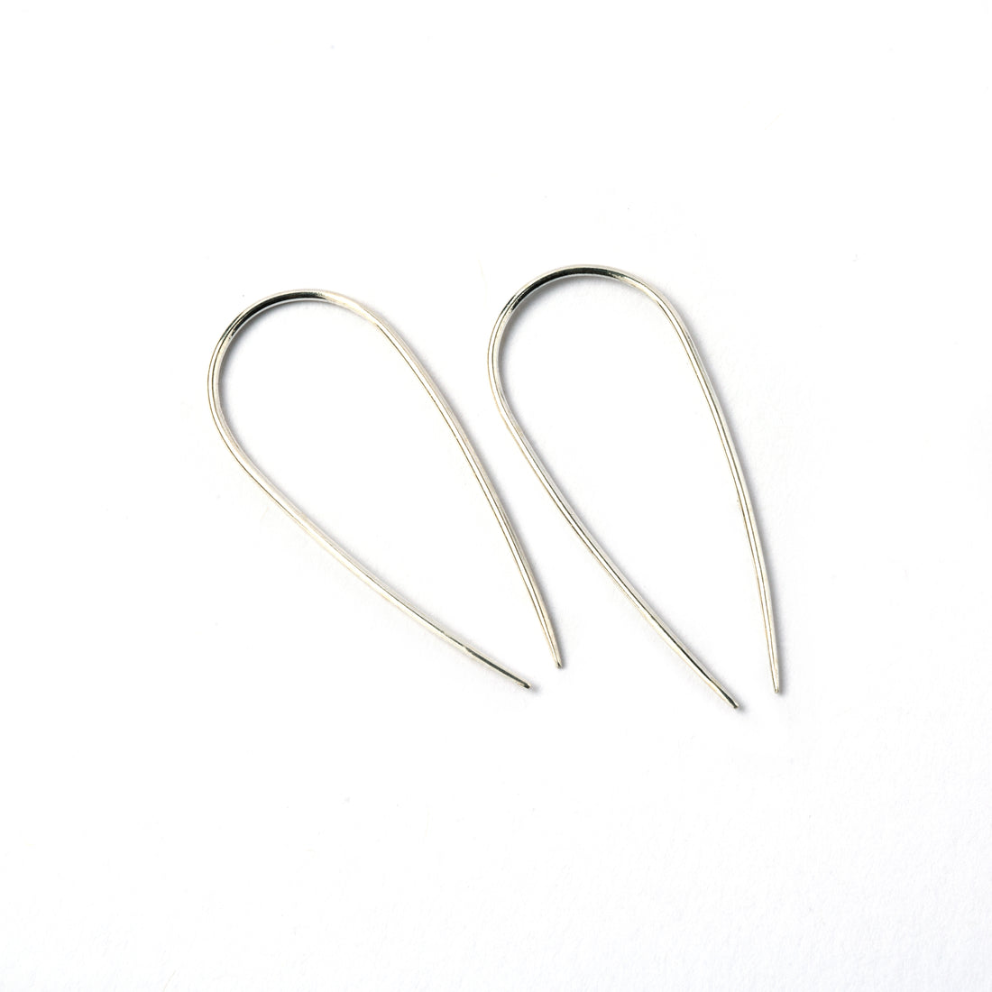 pair of silver wire long horseshoe earrings side view