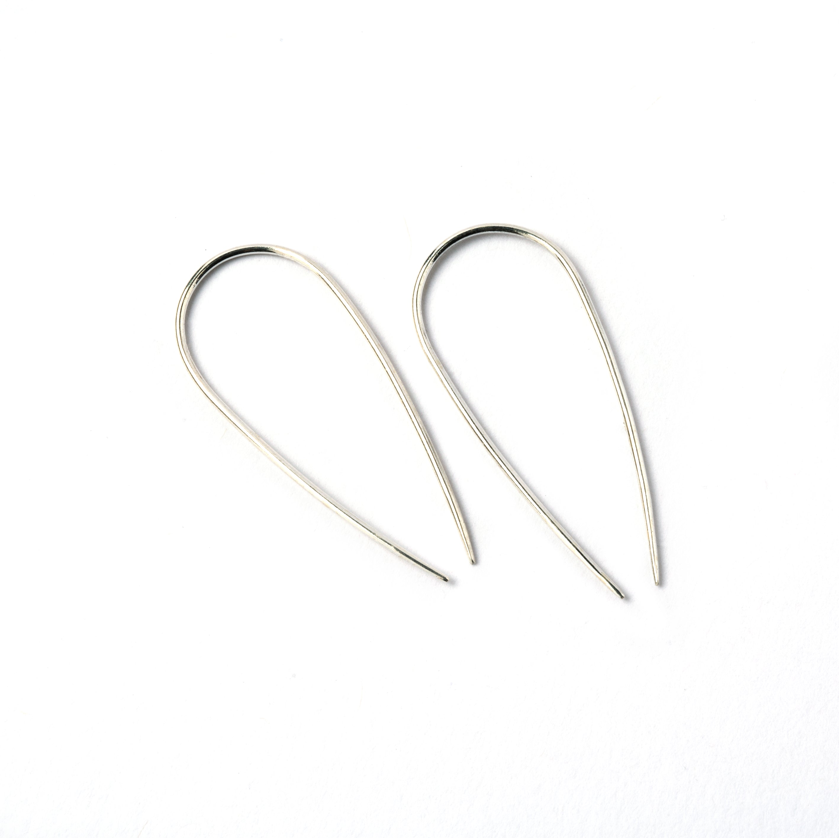 pair of silver wire long horseshoe earrings side view