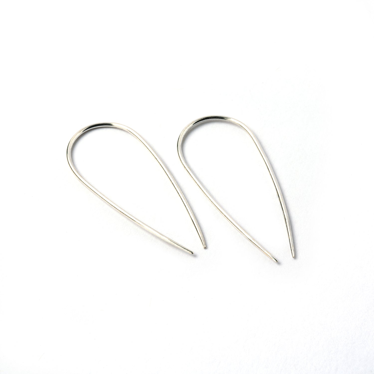 pair of silver wire long horseshoe earrings left side view