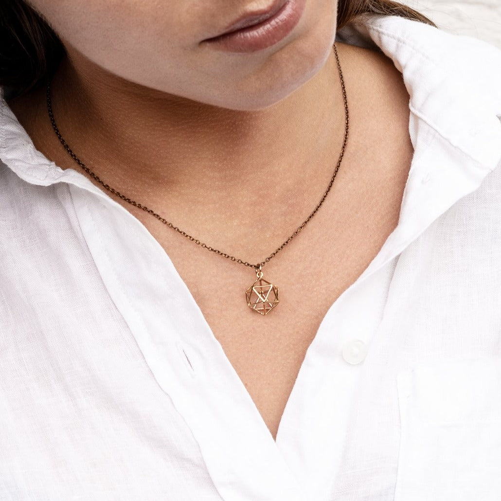 model wearing Bronze Icosahedron pendant necklace