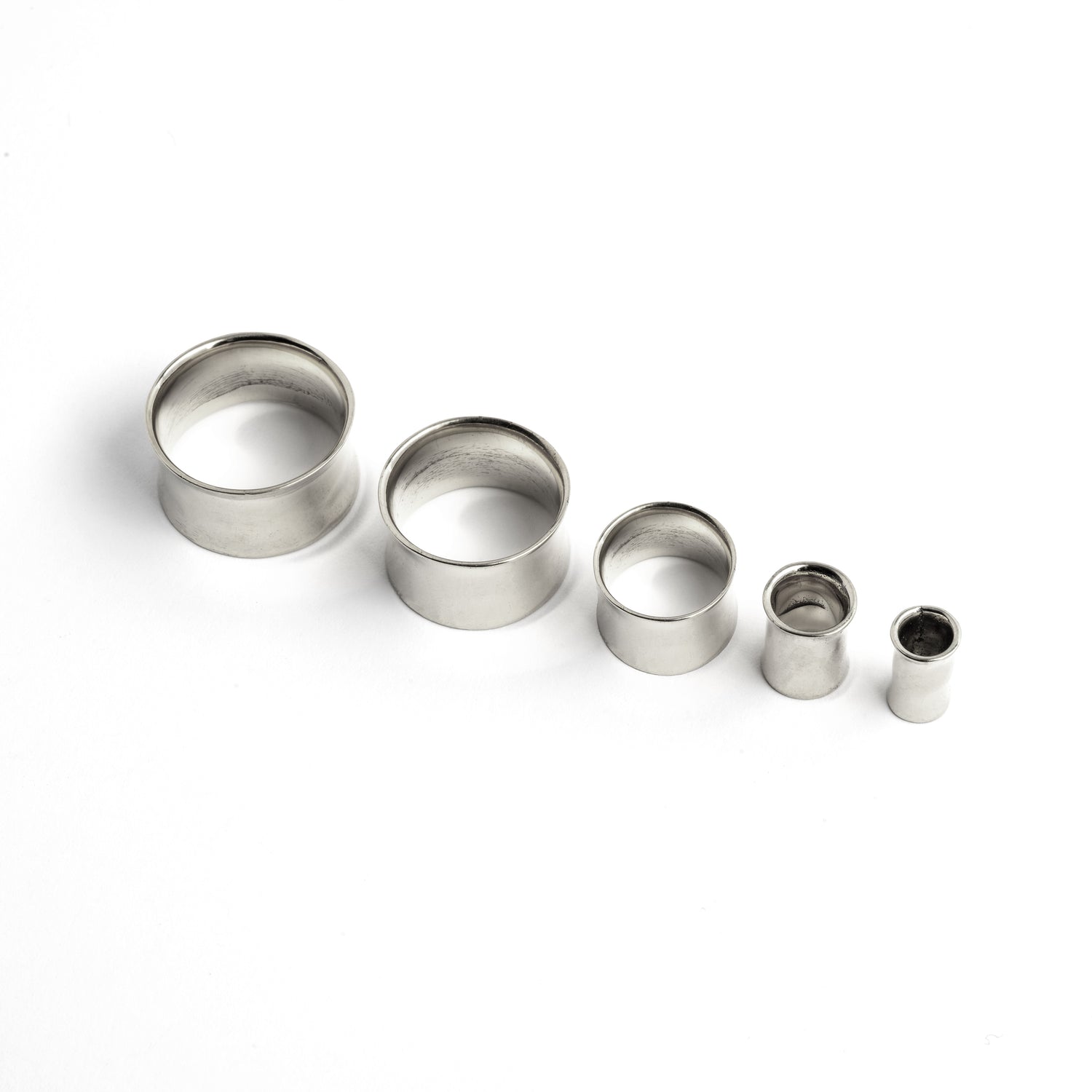 different sizes of minimalistic plain Silver ear tunnels frontal view