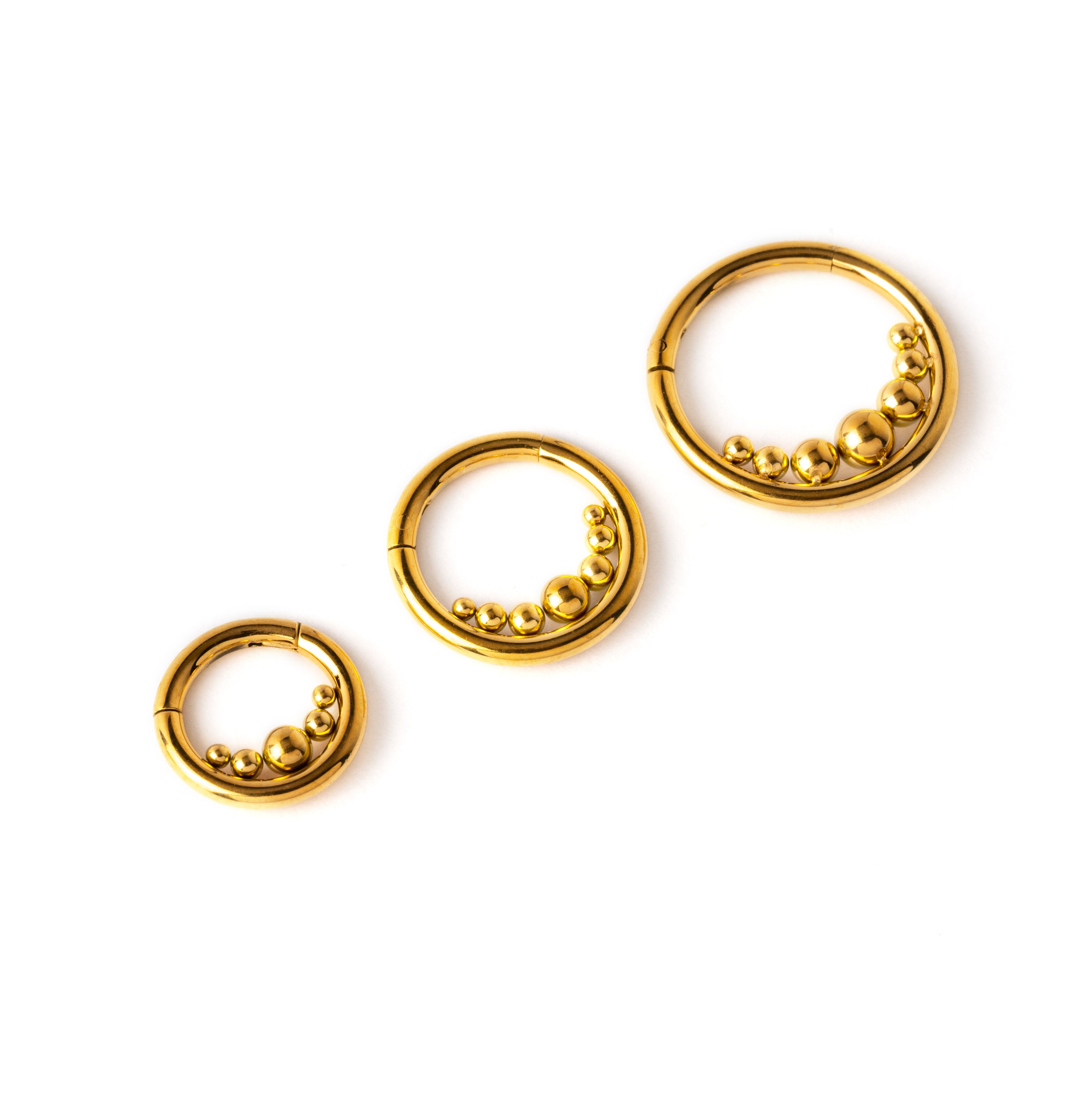 6mm, 8mm and 10mm Newton's Cradle gold surgical steel clicker piercing rings side view