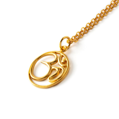 Gold Om stamp necklace on a chain left side view