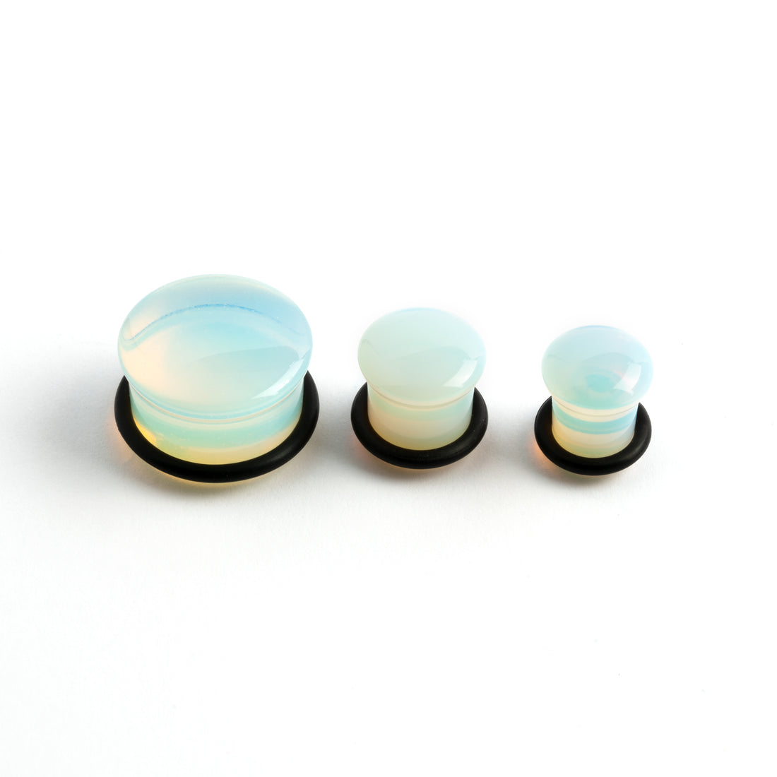 several sizes of Single flare Opalite stone ear plugs front  view