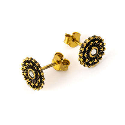 pair of boho chic golden open lotus ear studs with centred crystal