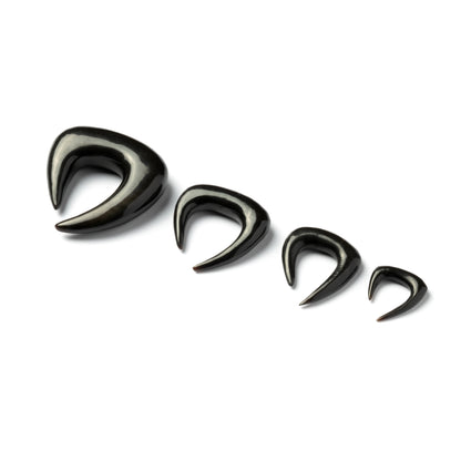 several sizes of open shape triangle ear stretchers right side view