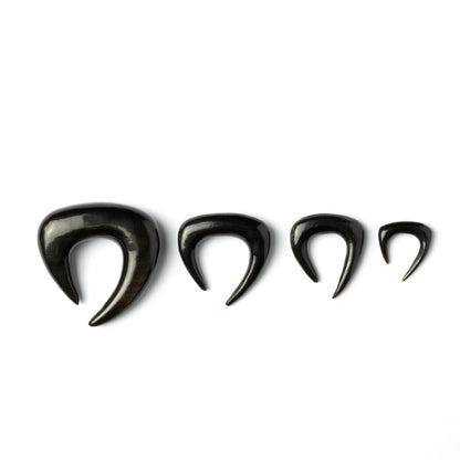 several sizes of open shape triangle ear stretchers side view