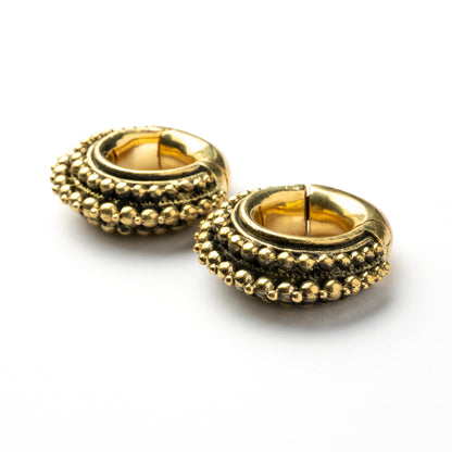 pair of gold brass chunky tribal ear weights hoops right down view