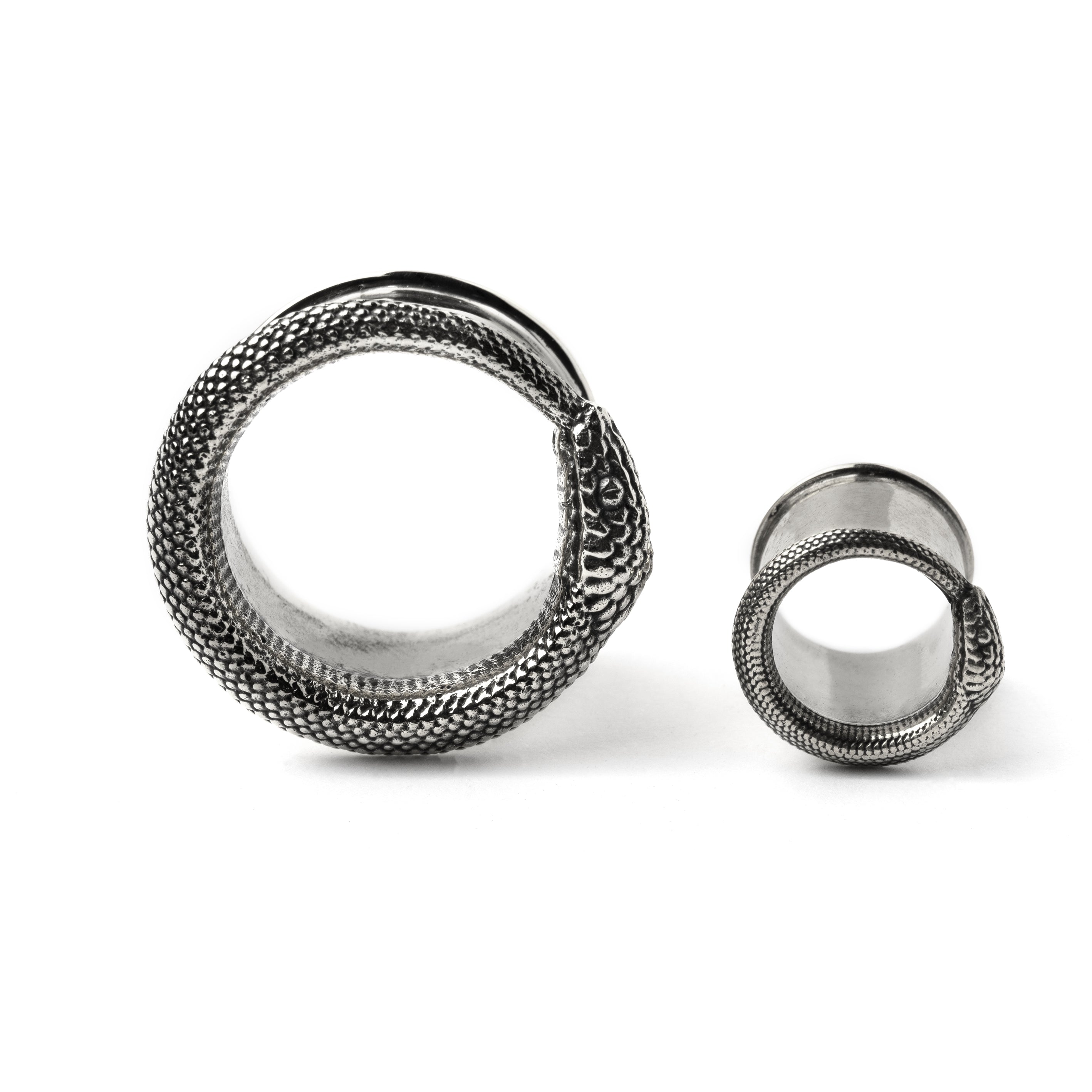 two sizes of Ouroboros silver ear tunnel frontal view
