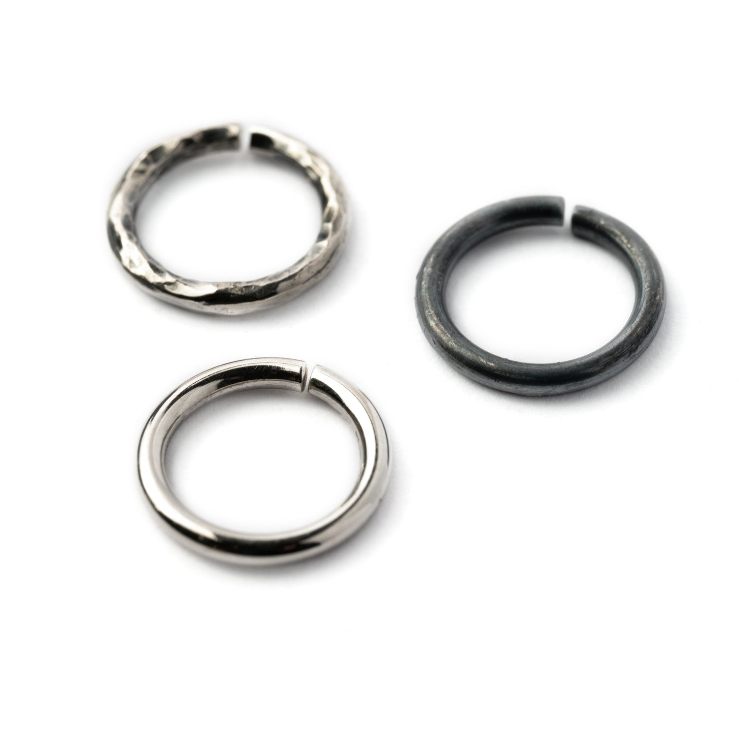 Plain silver, black hammered seamless piercing rings 