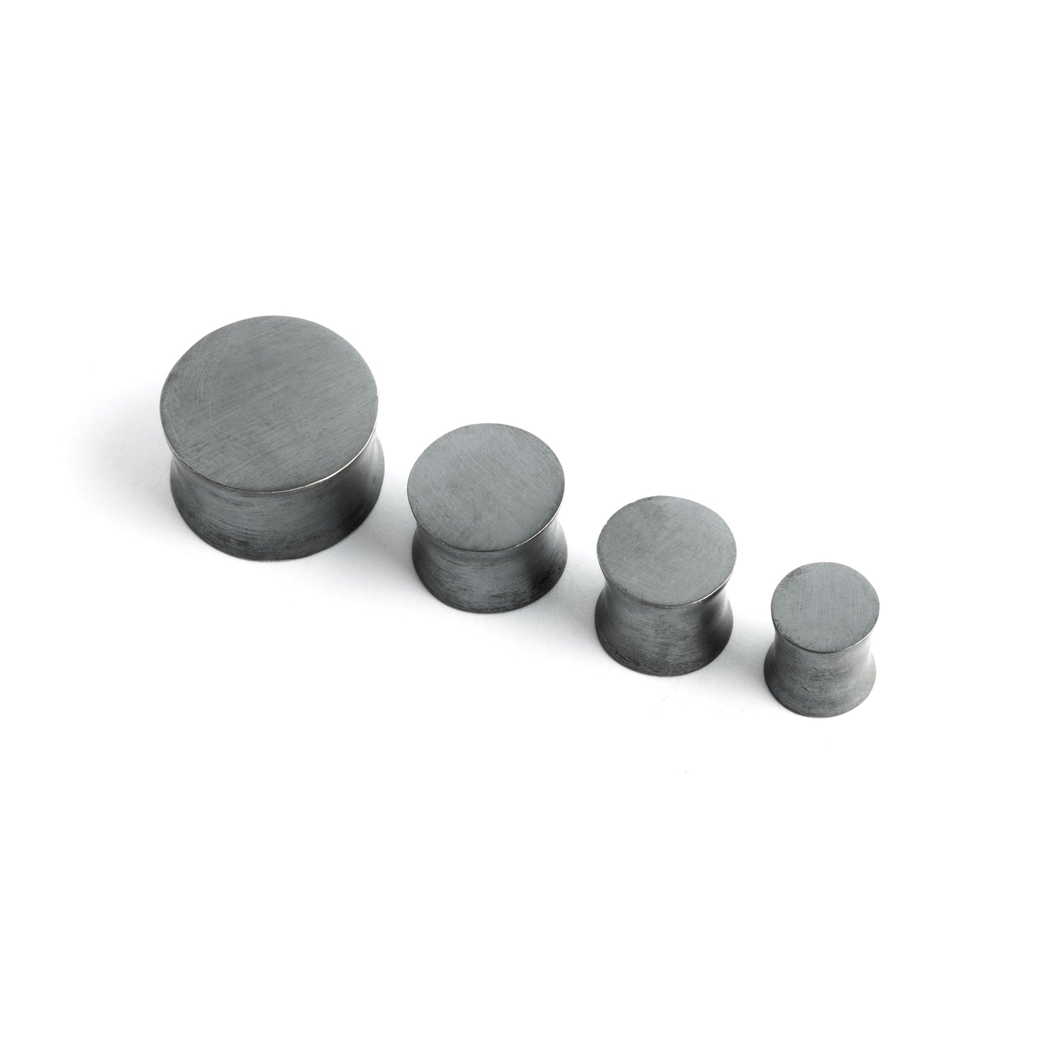 several sizes of double flared black silver ear plugs front view