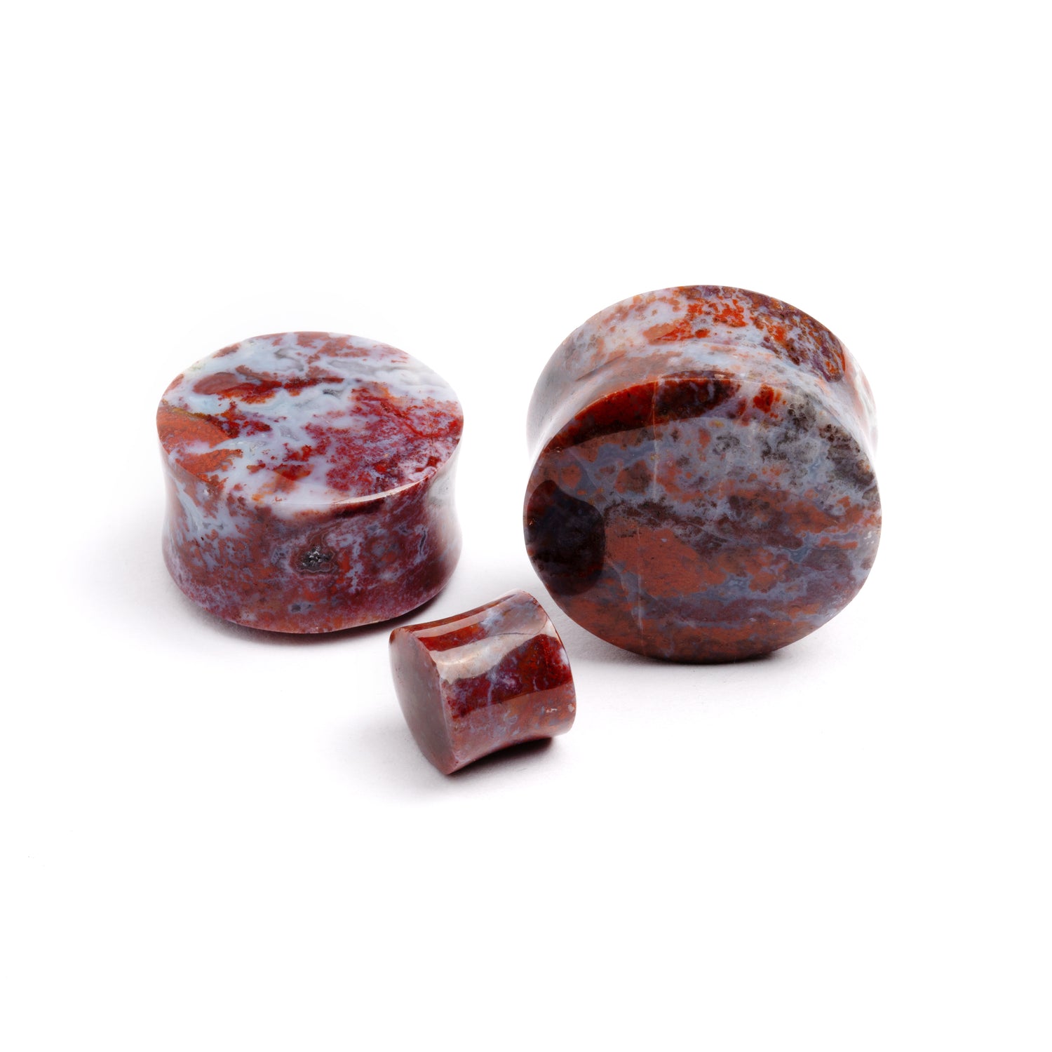 several sizes of Poppy Jasper double flare stone ear plugs front and side view