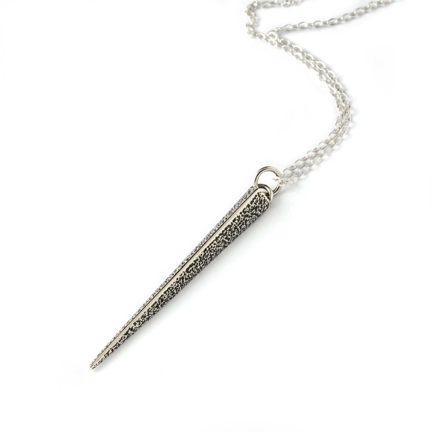 textured silver ridged spike pendant on a chain right side view