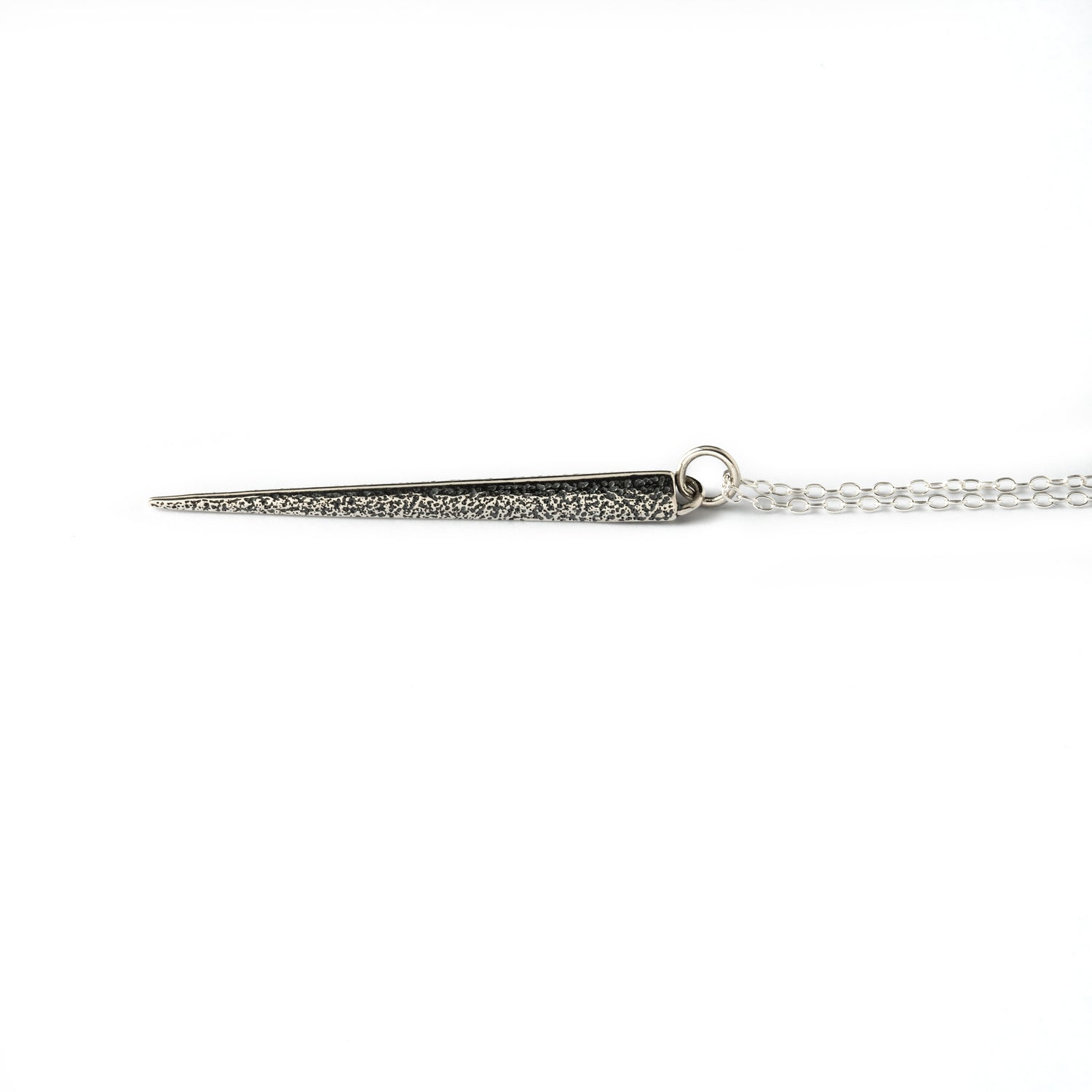 textured silver ridged spike pendant on a chain down view