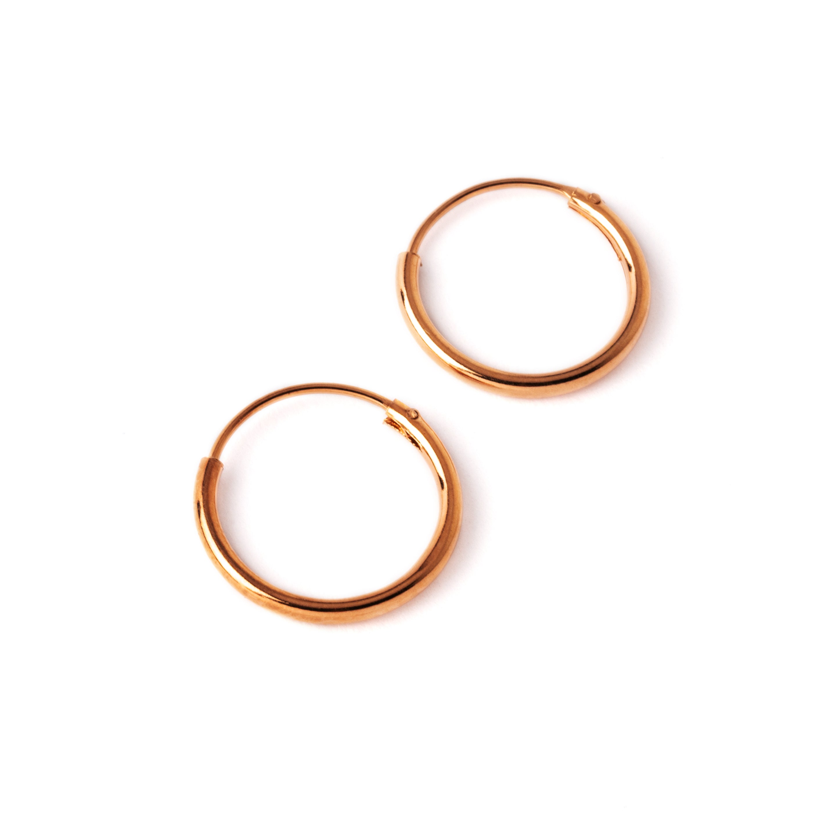 pair of rose gold hoop earrings side view