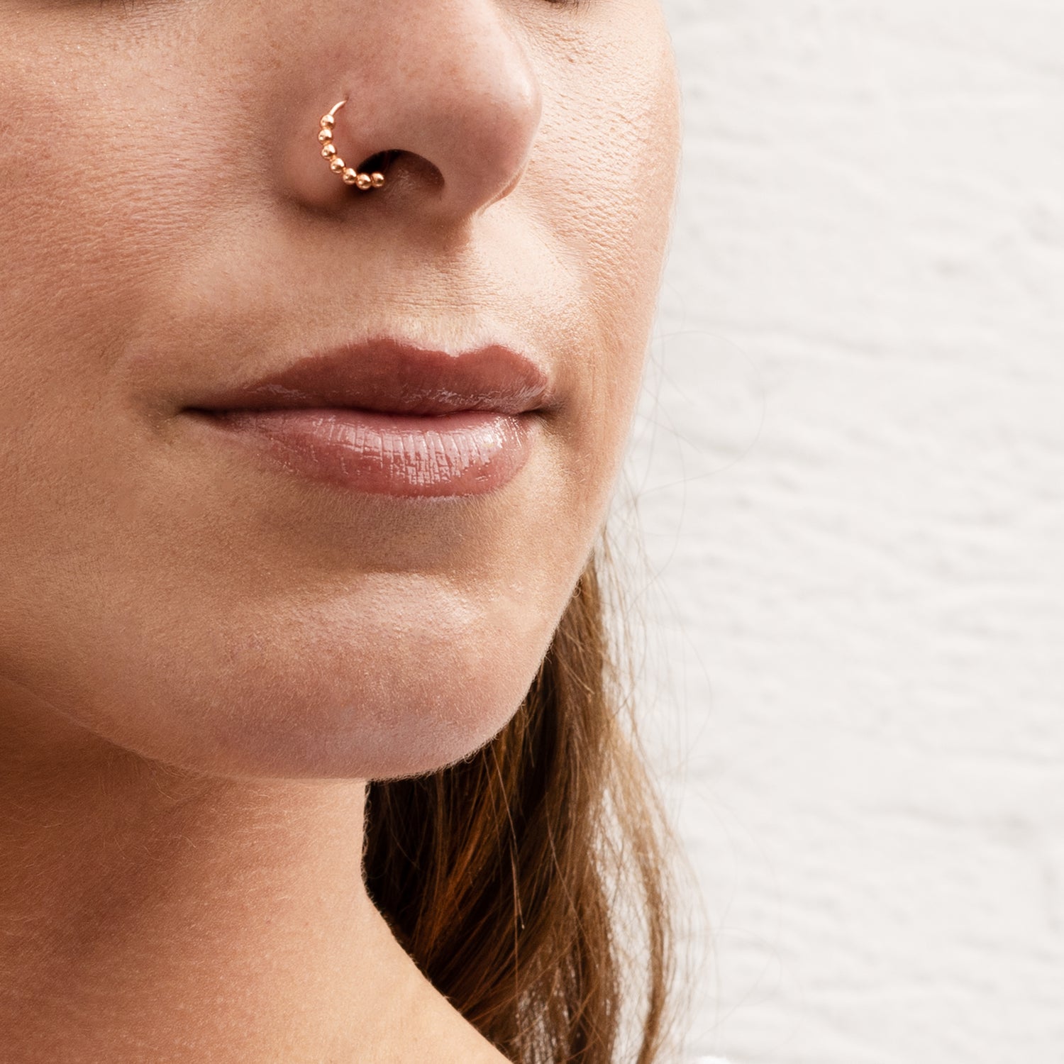 model wearing rose gold beaded nose ring