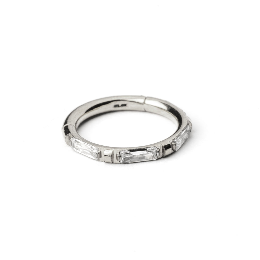 surgical steel septum clicker with crystal quartz around its rim frontal view