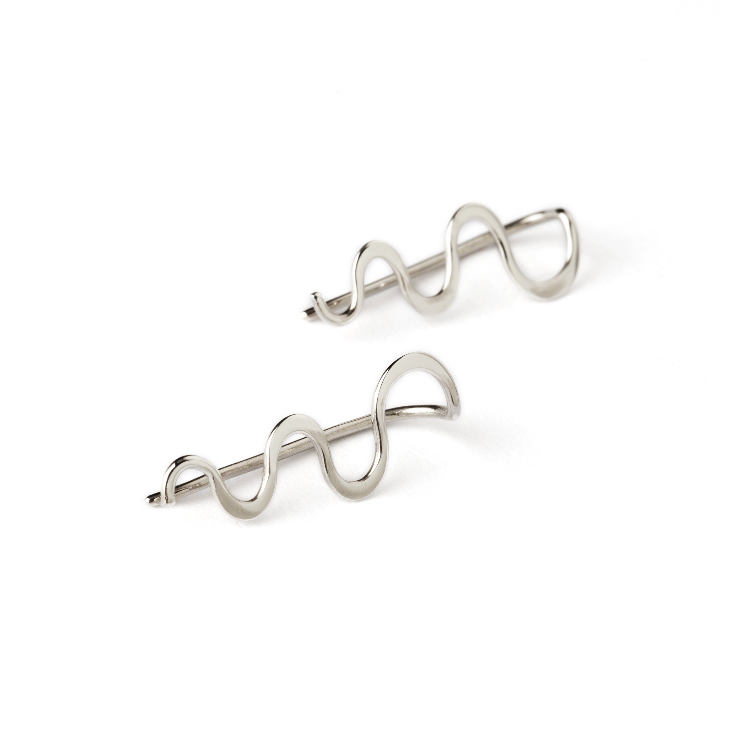 pair of silver wavy ear climbers front side view