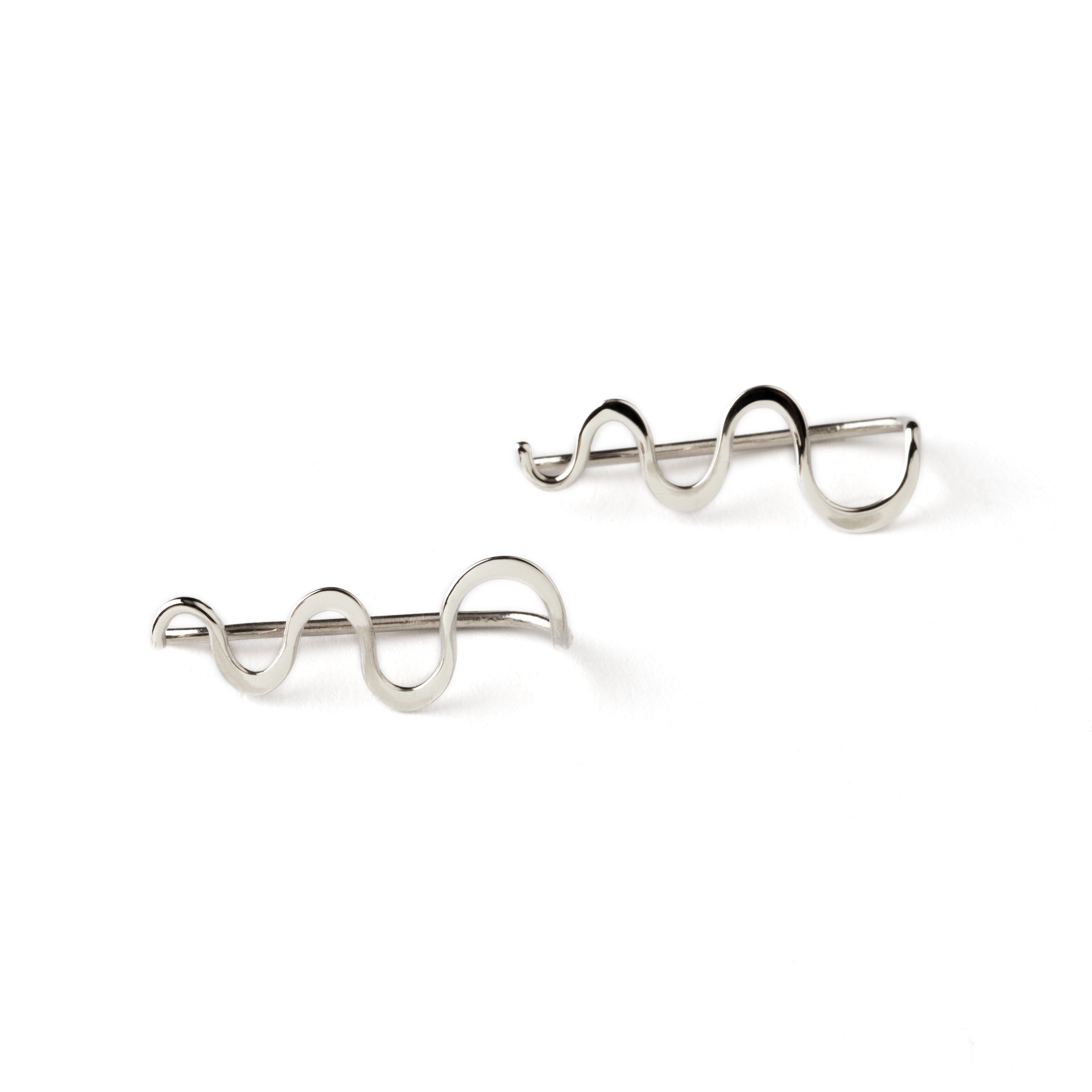 pair of silver wavy ear climbers frontal view
