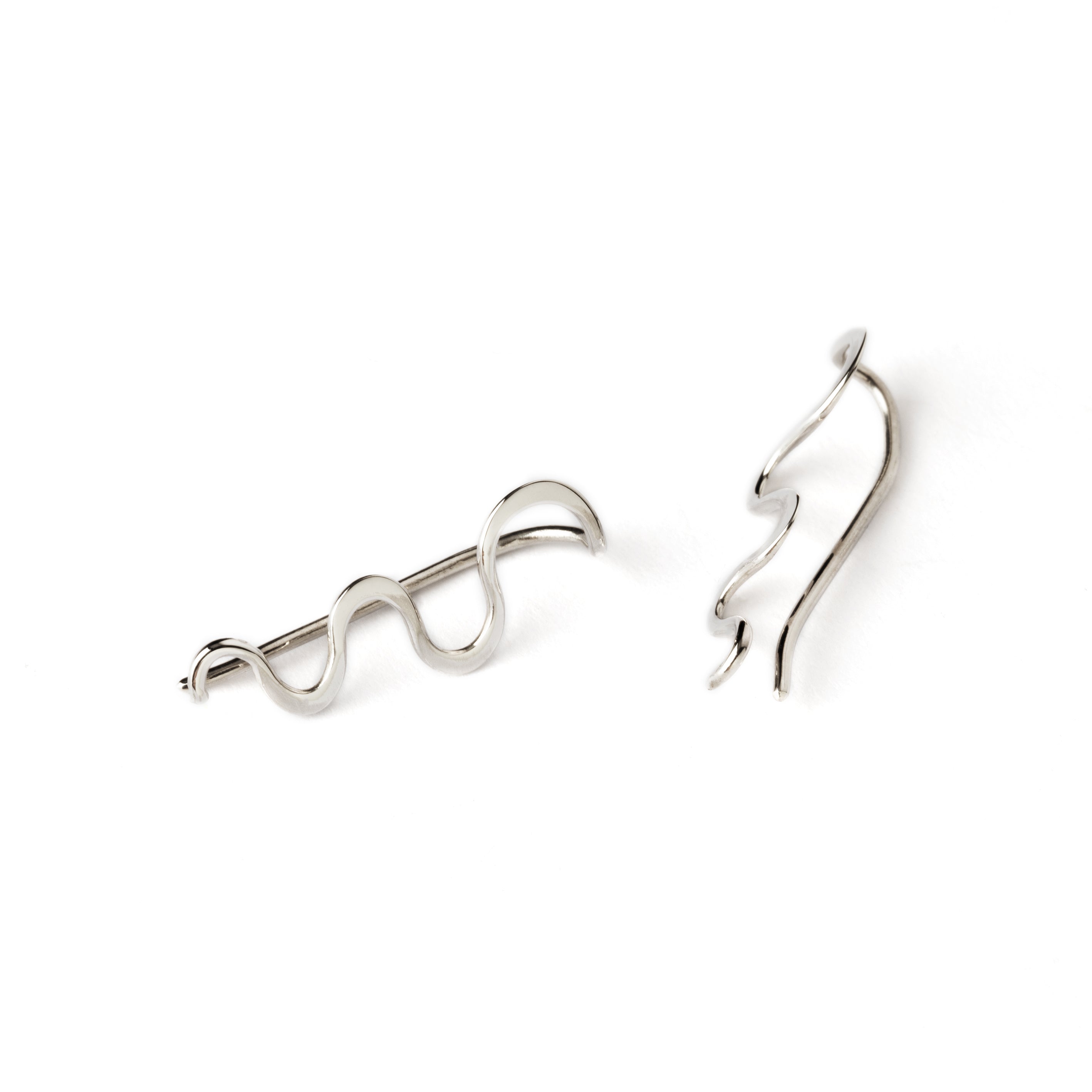 pair of silver wavy ear climbers front and side view