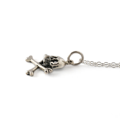 silver crossbones skull charm necklace down view