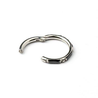 surgical steel septum clicker with black onyx stones around its rim closure view