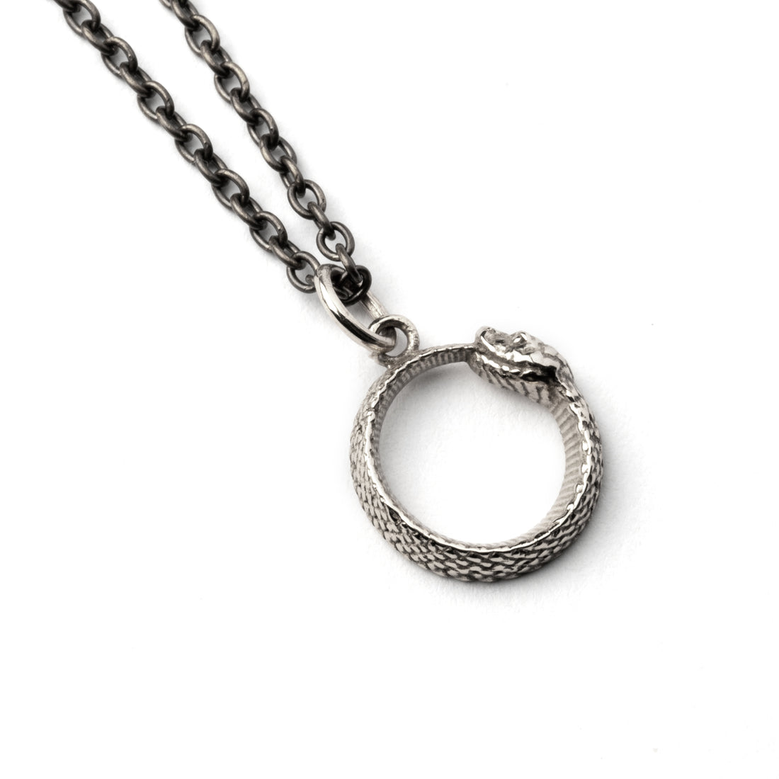 Tiny Silver Ouroboros Charm necklace left side view