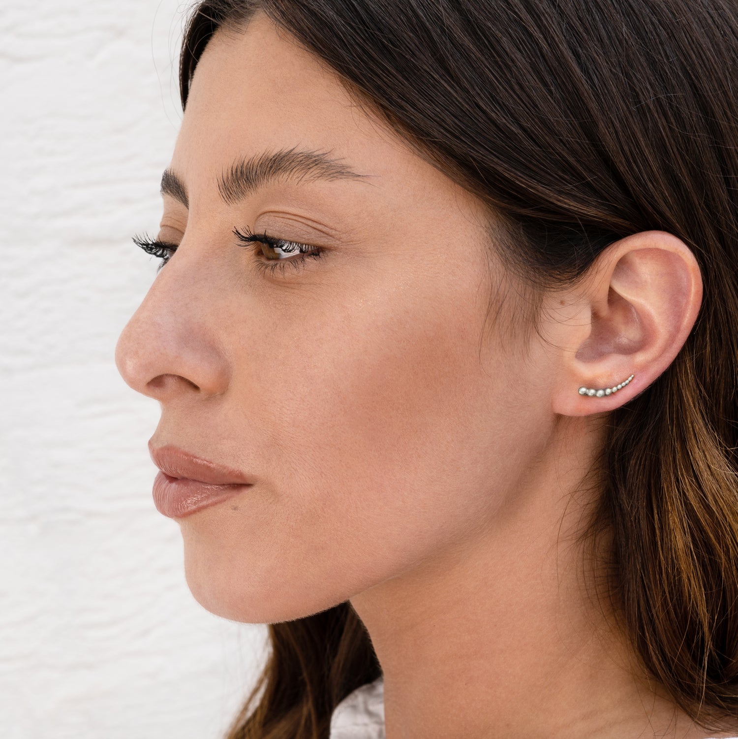 sterling silver multiple spheres ear climber on a model