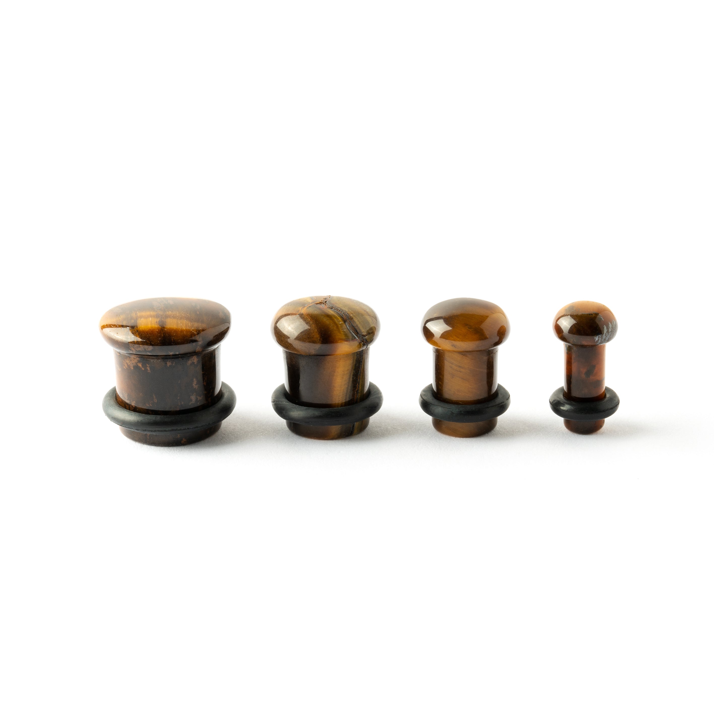 several sizes of Single Flare Tiger Eye stone ear plugs side view